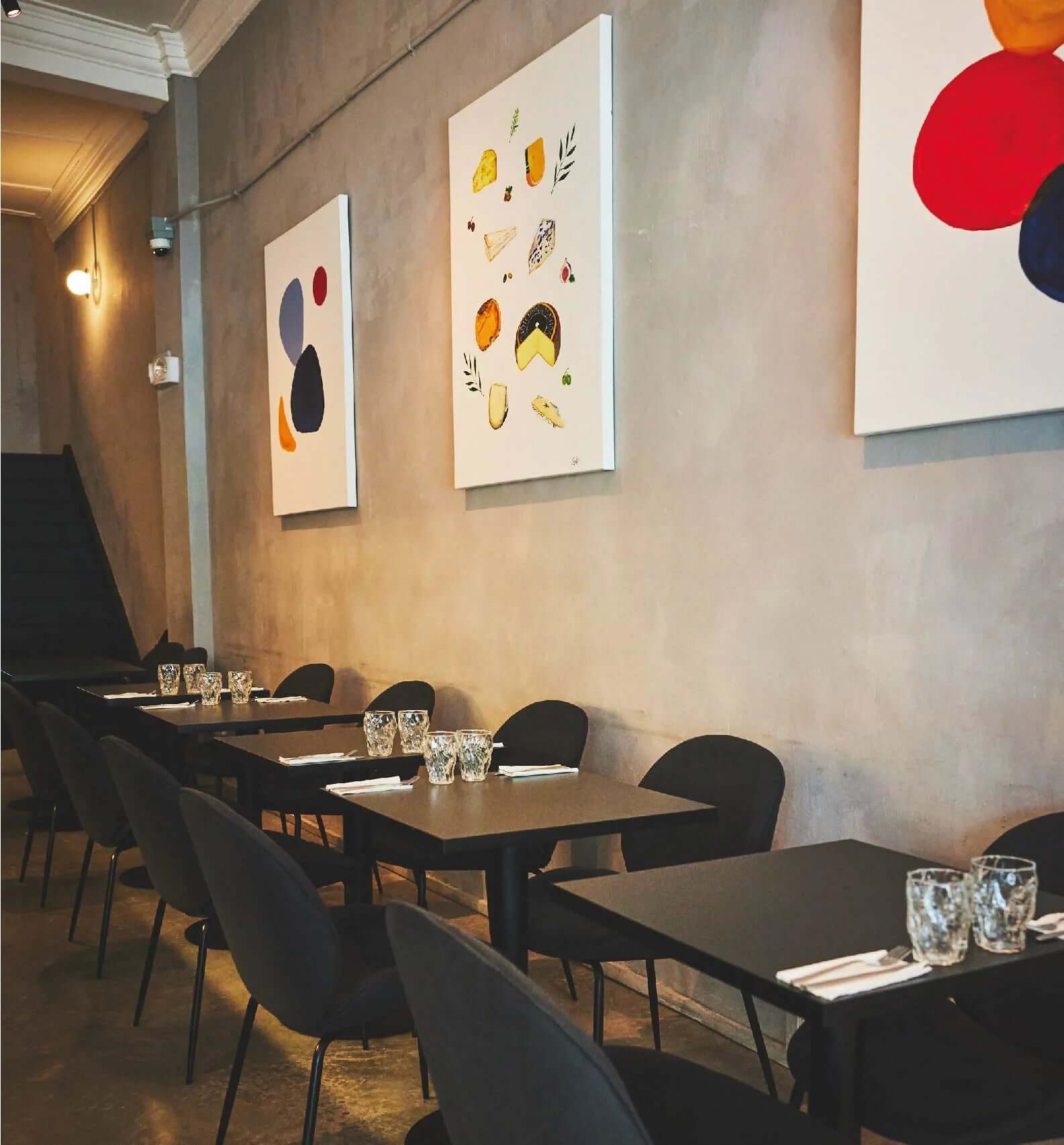 Inside of Cheeselads seating area, with chairs & tables