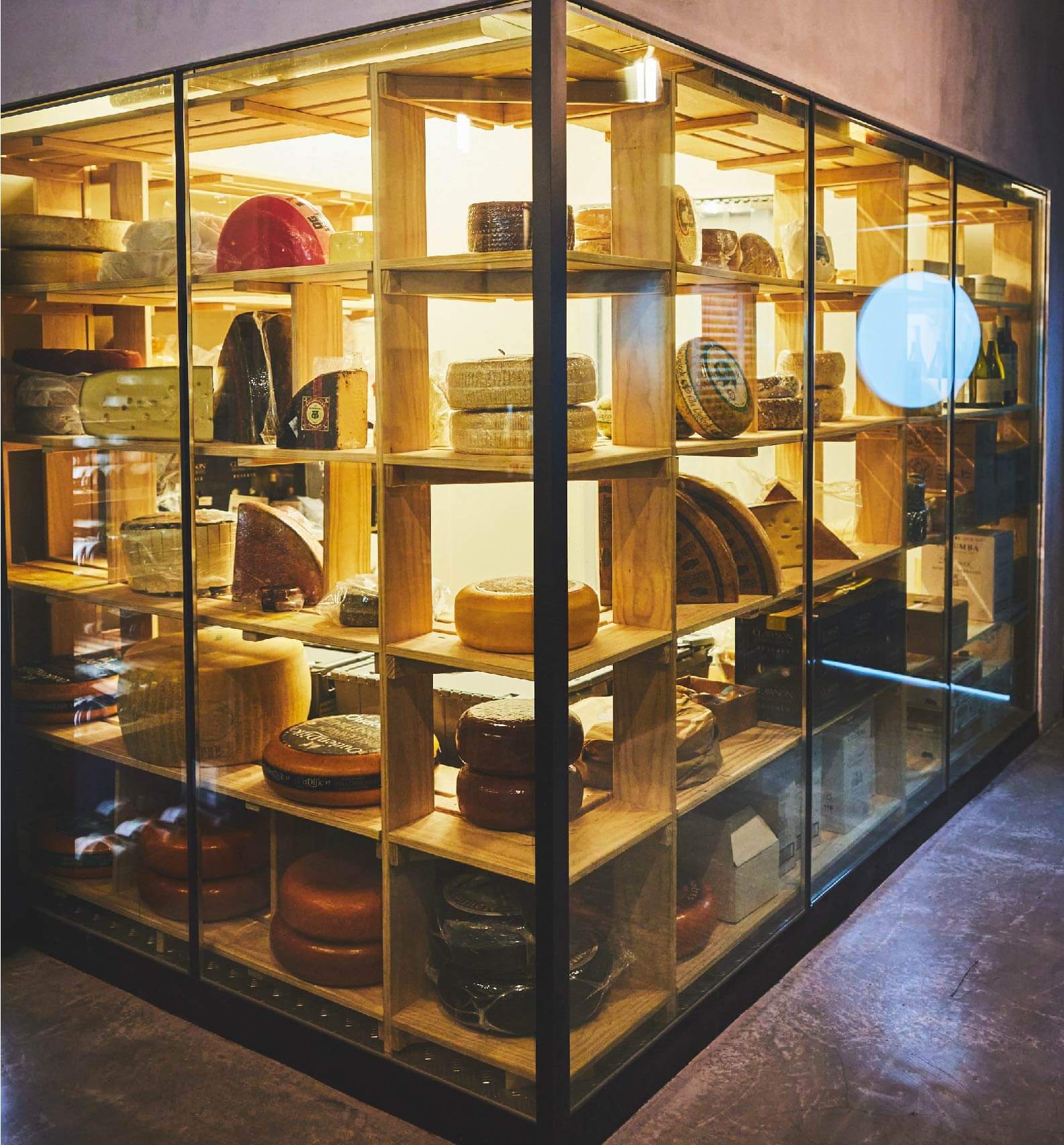 Glass showcase with various cheese varieties